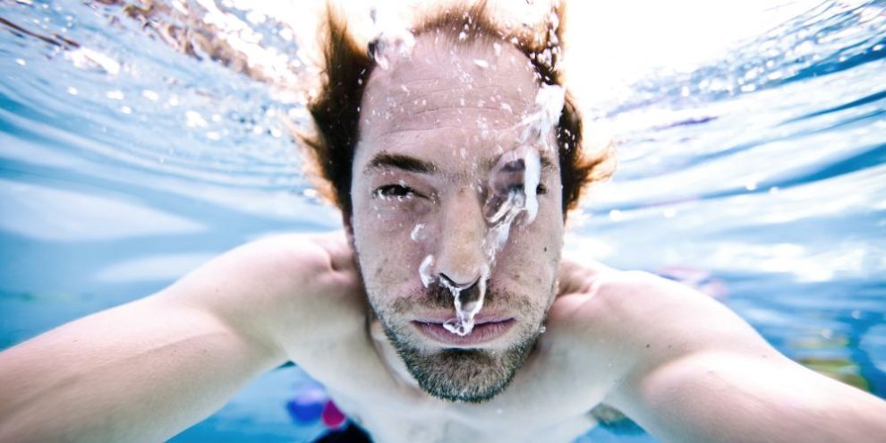 Man holding breath under water